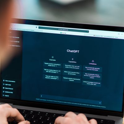 Close view of a man with opened AI chat on laptop